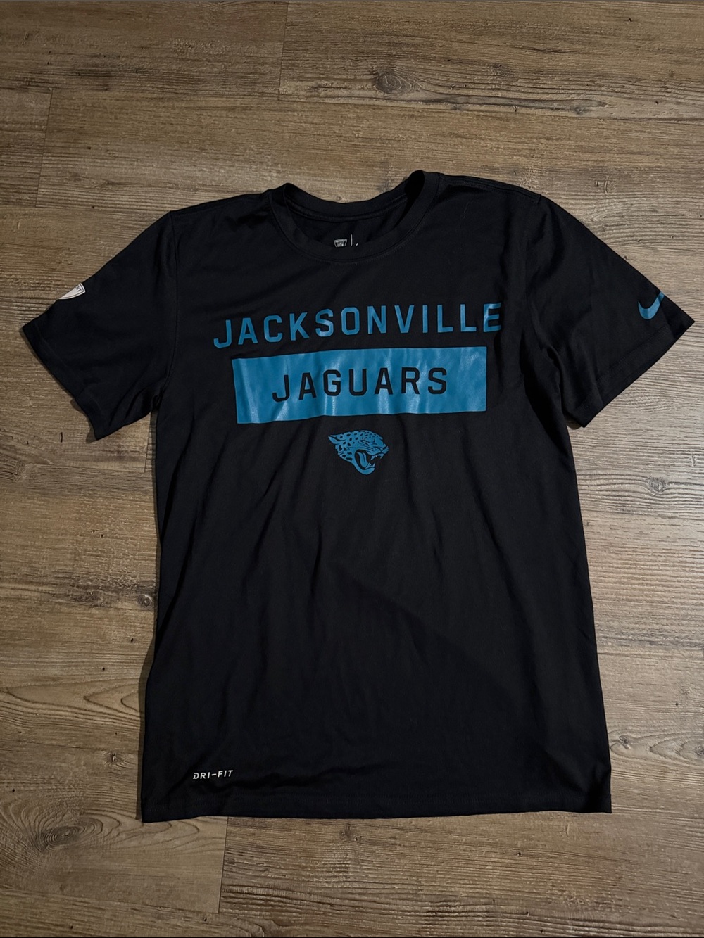 Nike Men’s Jacksonville Jaguars Dri-Fit Black Tee with Teal Graphics